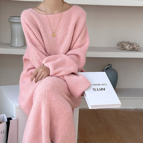 A Knee-length Knitted Sweater Dress Creates A Refined And Elegant Look For The Modern Woman